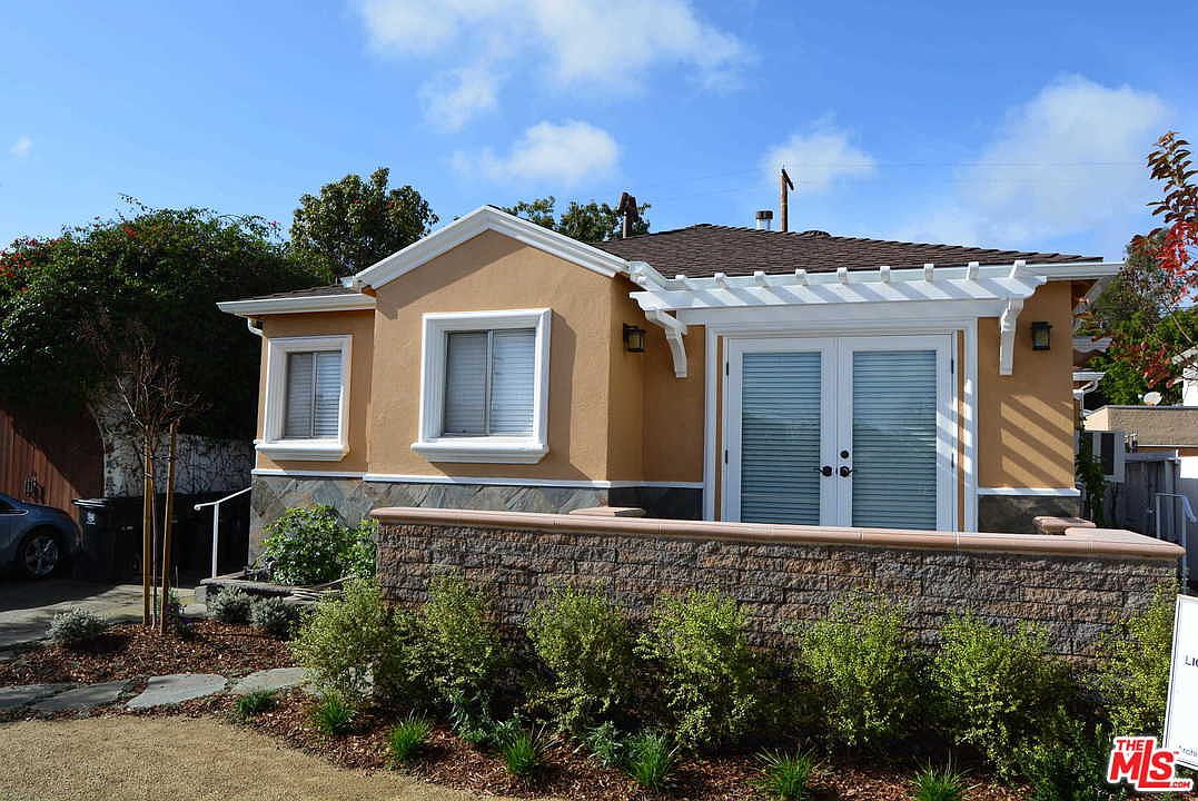 Street view of the duplex showing the front unit and pergola